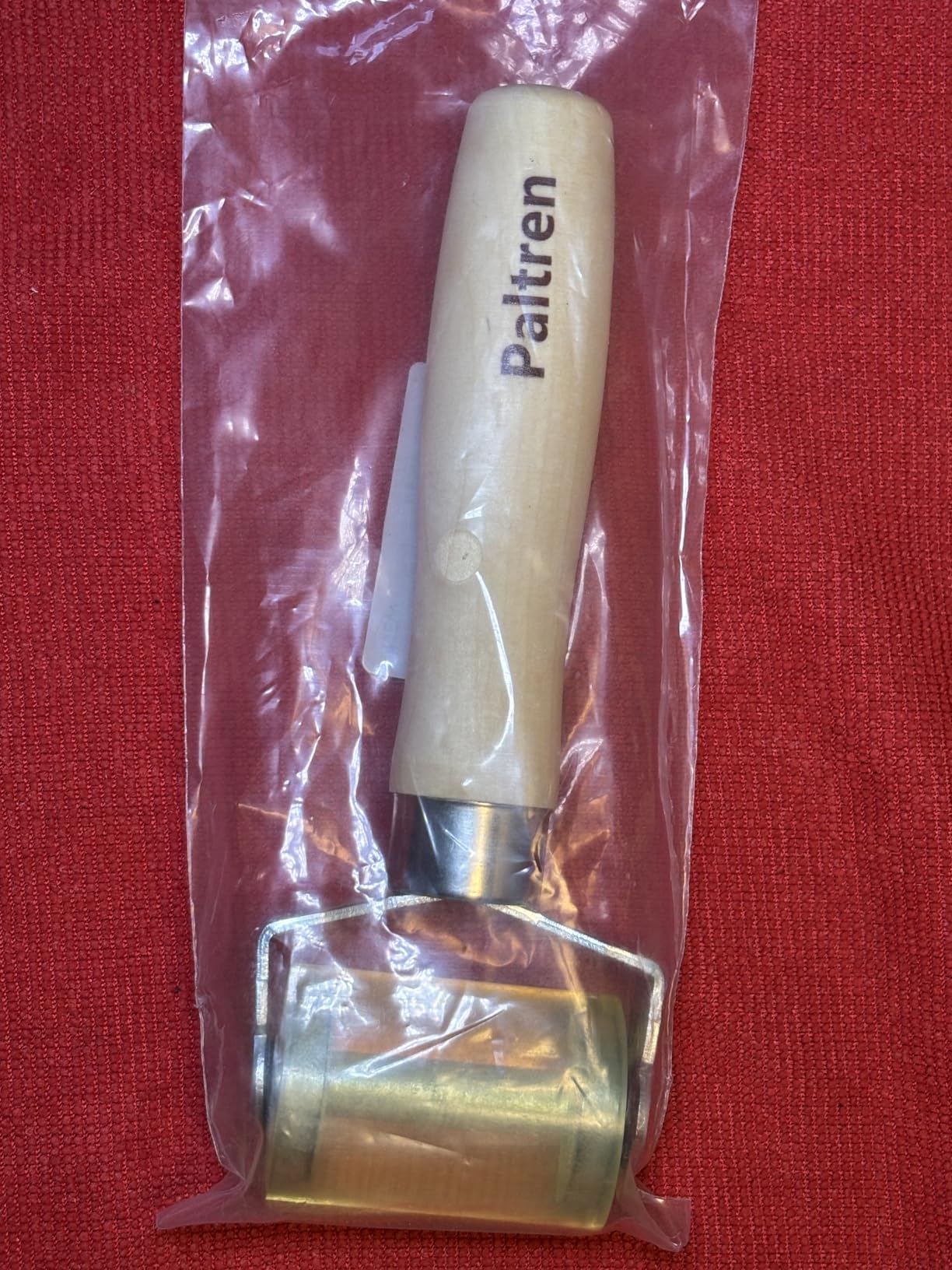 Seam roller gliding across layered fabric seams