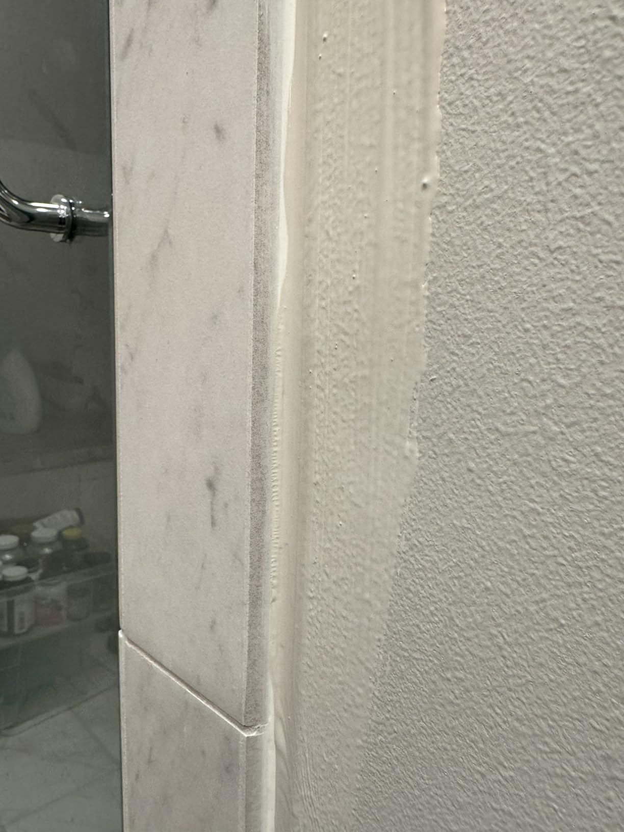 Paint edger tool positioned along a wall edge for cleaner trim work