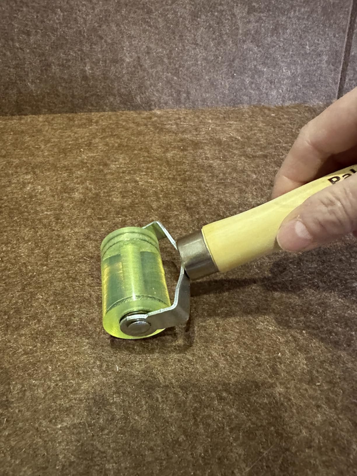 Using the Paltren sound deadening roller to press material firmly into place