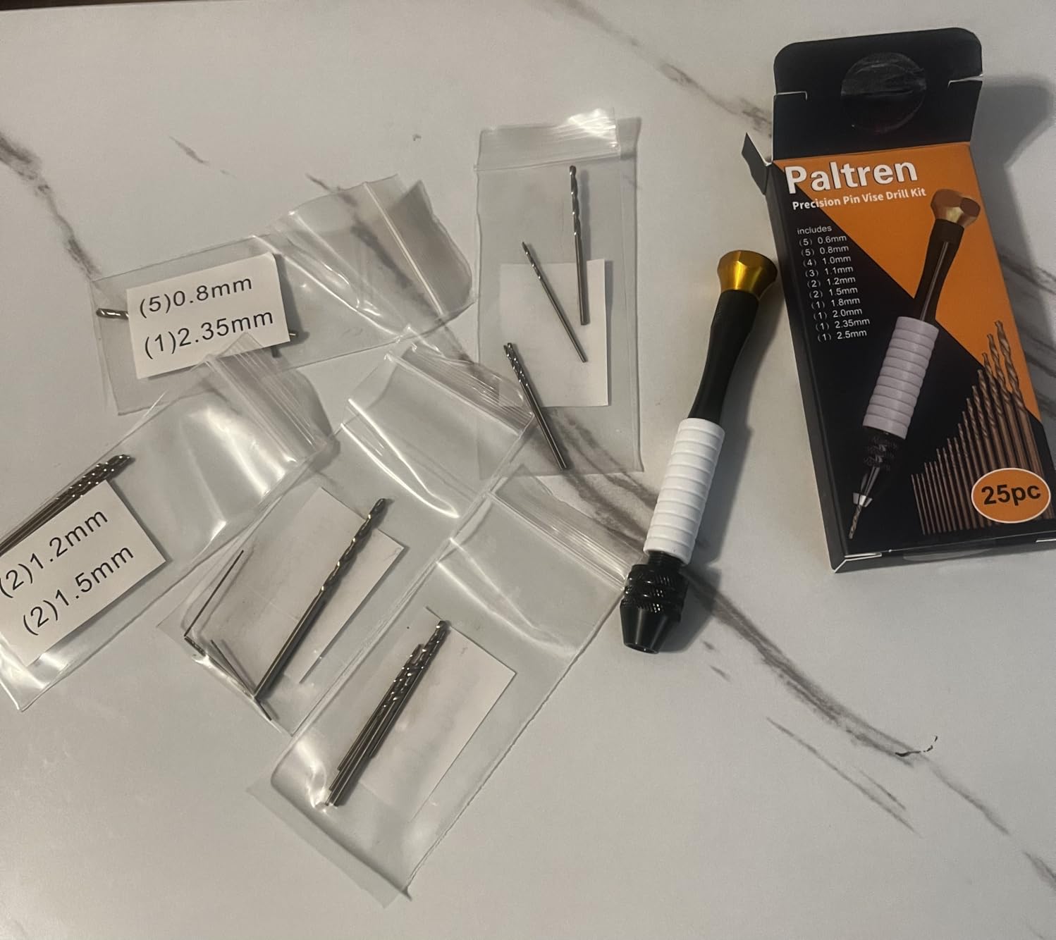 Manual drill and micro drill bits arranged for detailed work